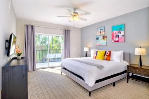 a bedroom with a large bed and a window at 3BR Condo with Hot Tub and Pool - Near Disney in Orlando