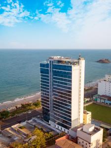 an aerial view of a tall building next to the ocean at Premier Pearl Hotel Vung Tau in Vung Tau