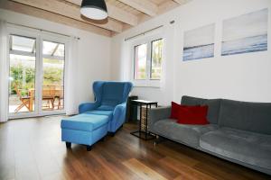 a living room with a couch and two chairs at Kugelberg 13 in Heiligenhafen