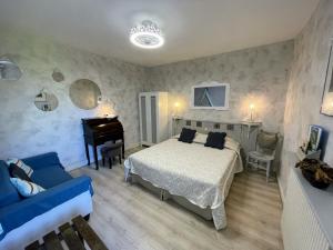 1 dormitorio con cama y piano en Maison du Manoir, en Vallon-Pont-dʼArc