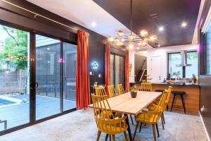 a dining room with a wooden table and chairs at Backyard Pool Oasis - Rainey Street - 6 min walk in Austin