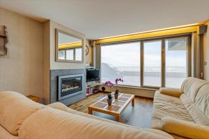 a living room with a couch and a fireplace at Rembrandt Glv in Wenduine
