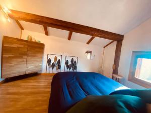 a bedroom with a blue bed and a wooden cabinet at Cocon à la vue imprenable ! in La Plagne Tarentaise