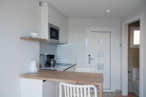 a kitchen with a wooden counter top in a room at Apartamentos Sunway Atlanta in Sitges