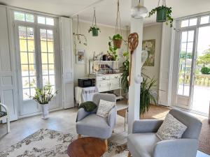 a living room with two chairs and a table at Maison Coqueréaumont in Montagne