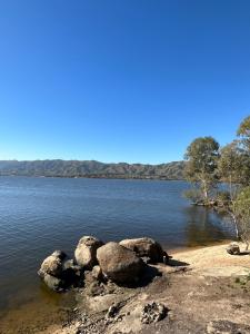 a body of water with some rocks in the water at Pasionaria Lake in Villa Parque Siquiman