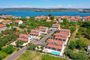an aerial view of a house with a lake at Papa's Court III Pasman Villa with pool in Pašman