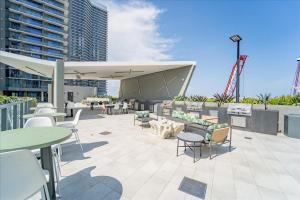 a patio with tables and chairs and a building at TR Miami 2 Bedroom Condo and Studio with Balcony in Miami