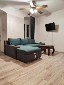 ein Wohnzimmer mit einem Sofa und einem Deckenventilator in der Unterkunft Iron Gates Apartments in Split