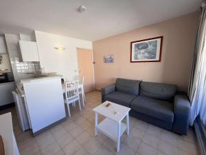 a living room with a couch and a kitchen at Appartement Saint-Raphaël, 2 pièces, 4 personnes - FR-1-226A-23 in Saint-Raphaël