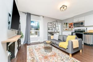 a living room with a couch and a tv at Cozy 1BR Apartment in Corso Italia in Toronto