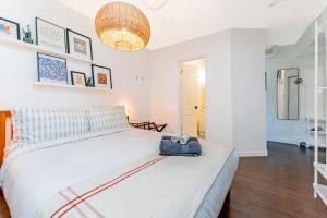 a bedroom with a large bed with a bag on it at Cozy 1BR Apartment in Corso Italia in Toronto