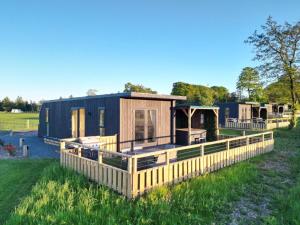 a modular house with a fence in a yard at South Black Hill in Penicuik