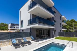a villa with a swimming pool and a house at Apartment Island Krk Queen 1 in Krk