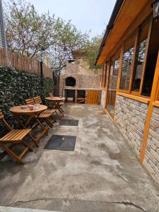 a patio with tables and chairs next to a building at Ionela in Eforie Nord
