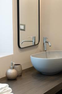 a bathroom with a white sink and a mirror at La Martina Home in Valguarnera Caropepe +36 photos