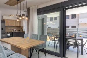 a dining room and kitchen with a table and chairs at Apartment Island Krk Queen 1 in Krk