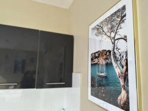 a picture of a painting of a boat on a wall at L'Escapade marine appartement avec jacuzzi privé in Cayeux-sur-Mer