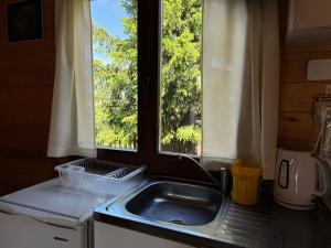 a kitchen with a sink and a window at Domek wakacyjny nr 2 in Giżycko