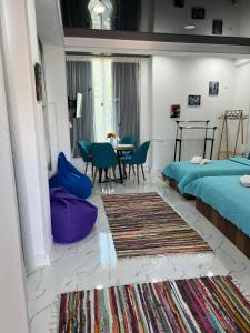 a bedroom with a bed and a table and chairs at Kutaisi Apartment in Kutaisi