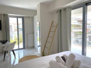 a bedroom with a bed and a desk and a ladder at Cottage Boutique Apartments Athens in Athens