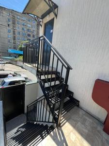 un balcon avec un escalier menant à une porte. dans l'établissement Kutaisi Apartment, à Koutaïssi