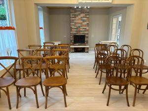 a room with chairs and tables and a fireplace at RestArt Boutique Hotel in Dilijan