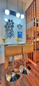 a bar in a kitchen with a bar stool at Stylish&Comfort Unit in Air Makati by Luca's Cove in Manila