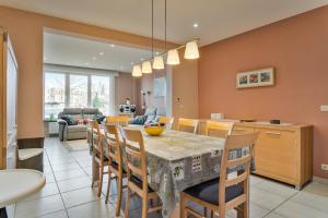 a kitchen and dining room with a table and chairs at Markt 28 Glvls in Wenduine