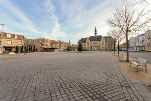 an empty street in a city with buildings at Markt 28 Glvls in Wenduine +4 photos