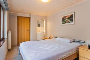 a bedroom with a large white bed in it at Markt 28 Glvls in Wenduine