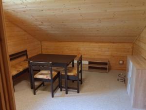 a room with a table and chairs in a cabin at Chaloupka u potůčku in Damníkov