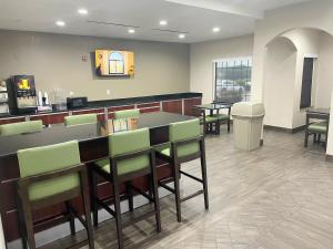 a bar with green chairs in a waiting room at Super 8 by Wyndham San Antonio/Alamodome Area in San Antonio