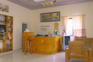 a living room with a wooden cabinet and a window at Khách Sạn An Bình Đảo Phú Quý in Phú Quý