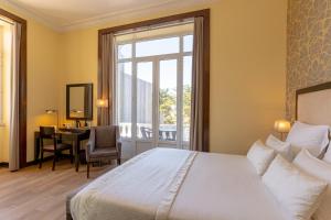 Cama ou camas em um quarto em Hotel Inglaterra - Charme & Boutique