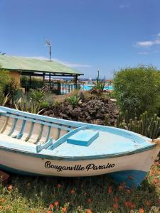 a boat sitting on the grass in front of a house at Casa ART residenza Bouganville in Costa de Antigua