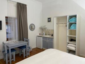 羅伯特森的住宿－Green Olive Guesthouse，一间卧室配有一张床、一张桌子和一个水槽
