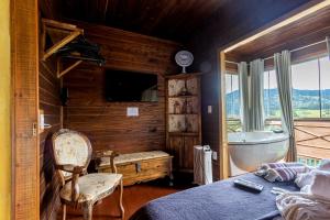 Postel nebo postele na pokoji v ubytování CHALÉ DO CAPITÃO com Hidro - URUBICI