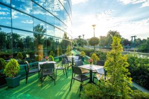un patio con tavoli e sedie in un edificio di HP Park Plaza a Breslavia