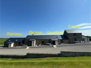 a building with the words summer greenhouse and calgary istg at Ramsey Sea View Cottage - Dog Friendly in Pembrokeshire +4 photos
