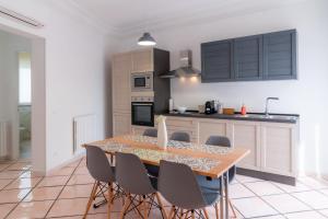 a kitchen with a wooden table and chairs at MONDELLO COTTAGE in Mondello