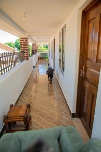 a black dog walking down a hallway at Gangilonga Home's in Iringa
