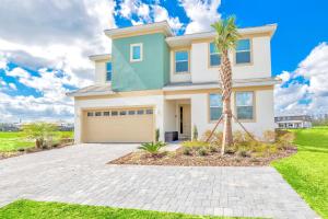 a house with a palm tree in front of it at Family Resort - 12BR Mansion - Sleeps 28 - Private Pool, BBQ and Games Room! in Kissimmee