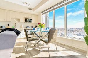 a kitchen and dining room with a table and chairs at Luxury 1BR Condo - Private Balcony City Views in Kitchener