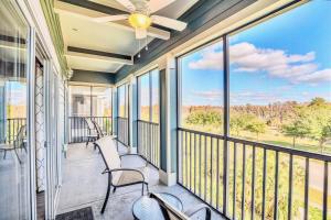 a screened porch with chairs and a ceiling fan at Upscale 3BR Near Disney - Pool and Hot Tub! in Orlando