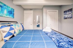 a room with a bed with a blue comforter at Corktown Apartment on James St South in Hamilton