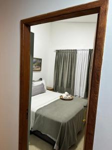 espejo reflejo de una cama en un dormitorio en Pousada Pé na Areia, en Abraão