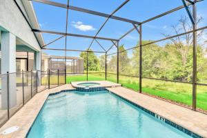 an indoor swimming pool in a house at Stunning Rare Lake Front 7BR Holiday Home - Sleeps 14 - Pool, Hot Tub, & Games! in Orlando