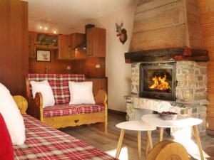 a room with a fireplace and a bed and a couch at Appartement Valloire, 4 pièces, 8 personnes - FR-1-263-155 in Valloire