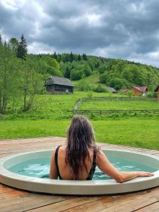 a woman laying in a pool of water in aractor at Scrind 11 - Madleine Chalet in Cluj-Napoca